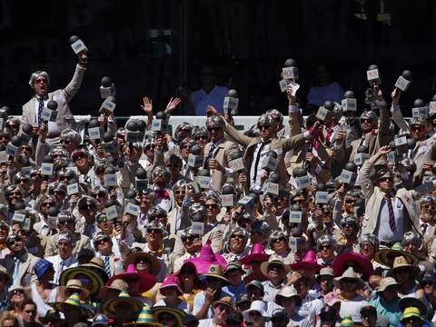 Members of the crowd dressed as former Australian cricketer and commentator Richie Benaud react during the second day's play in the fourth test between Australia and India at the Sydney Cricket Ground (SCG) January 7, 2015. REUTERS/David Gray (AUSTRALIA - Tags: SPORT CRICKET TPX IMAGES OF THE DAY) - RTR4KB5Z