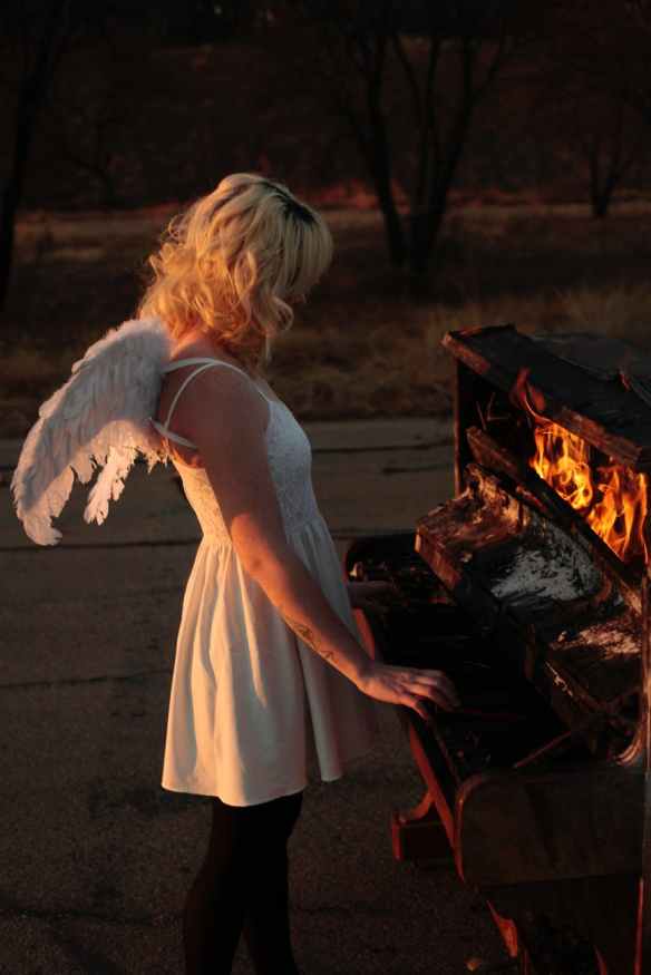 woman playing on burning piano