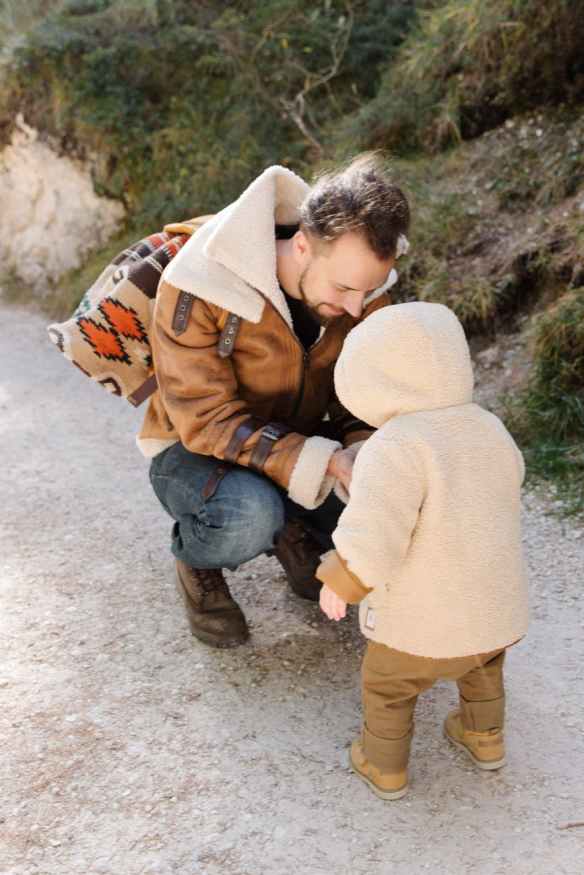 man in brown jacket with his child wearing brown hoodie